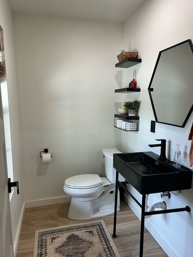 489 Skipper Rd, Malvern, AL 36375 - half bath with baseboards, toilet, and wood finished floors