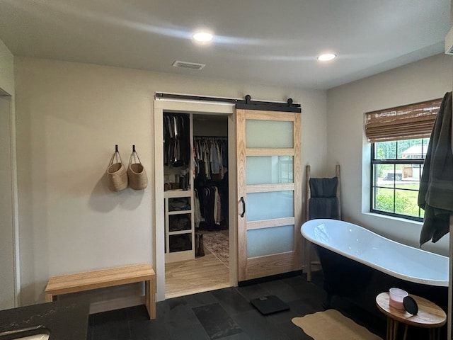 489 Skipper Rd, Malvern, AL 36375 - bathroom with visible vents, recessed lighting, a freestanding bath, and a spacious closet