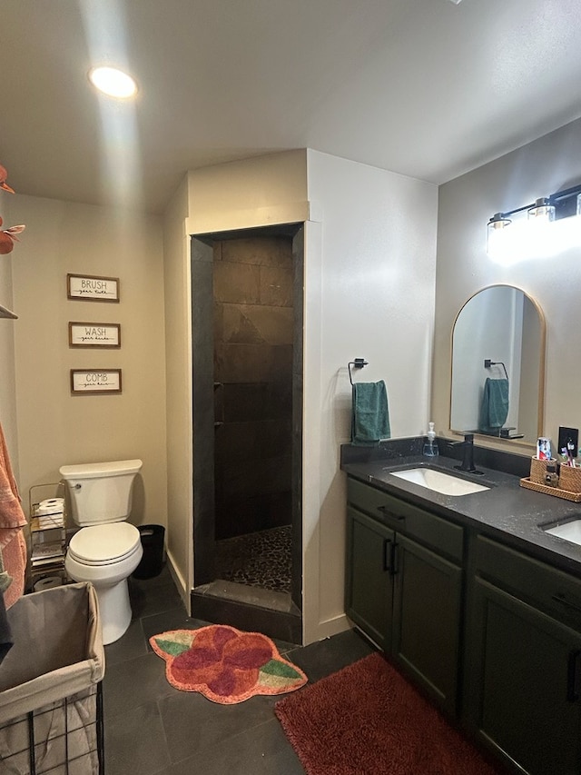 489 Skipper Rd, Malvern, AL 36375 - full bathroom featuring double vanity, toilet, a tile shower, and a sink