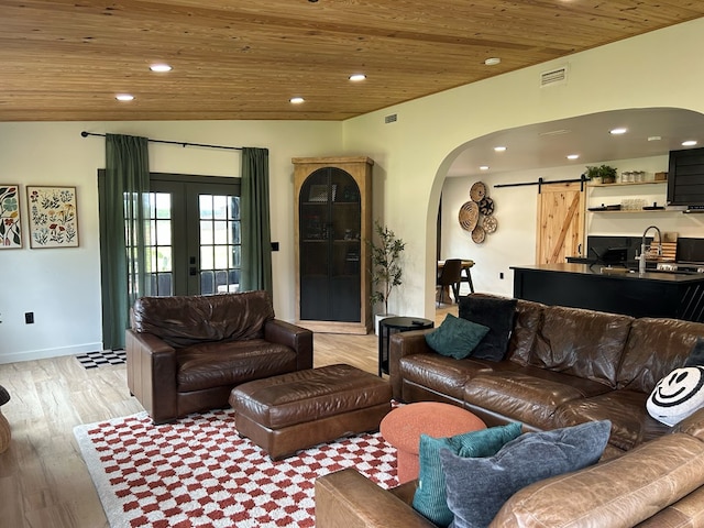 489 Skipper Rd, Malvern, AL 36375 - living room featuring visible vents, a barn door, wooden ceiling, french doors, and arched walkways
