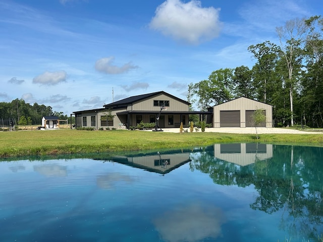 489 Skipper Rd, Malvern, AL 36375 - rear view of house featuring a lawn, a water view, and a detached garage