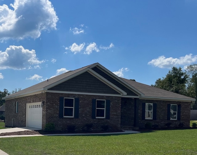 view of front of property with a garage and a front lawn