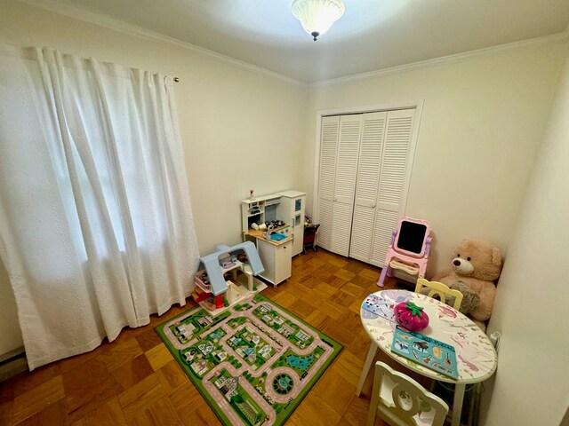 recreation room with crown molding and parquet flooring