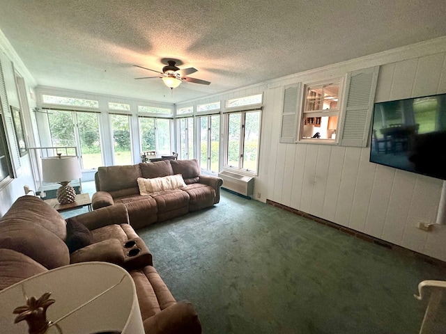 living room with a textured ceiling, dark carpet, and ceiling fan