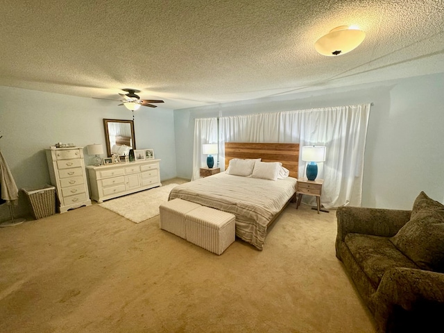 bedroom with light carpet, a textured ceiling, and ceiling fan