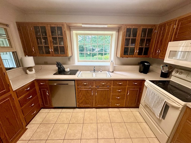 kitchen with crown molding, sink, light tile patterned flooring, and white appliances