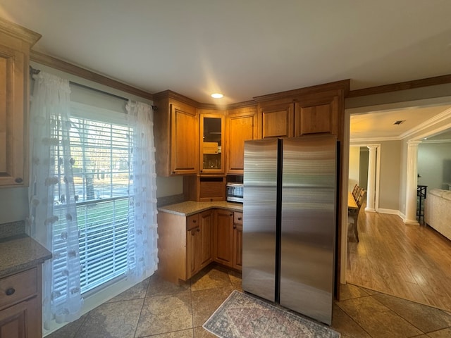 kitchen with stainless steel refrigerator and crown molding