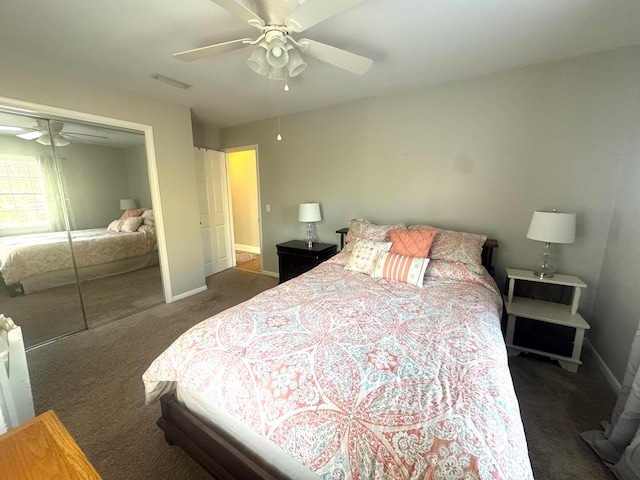 bedroom featuring ceiling fan, a closet, and dark colored carpet