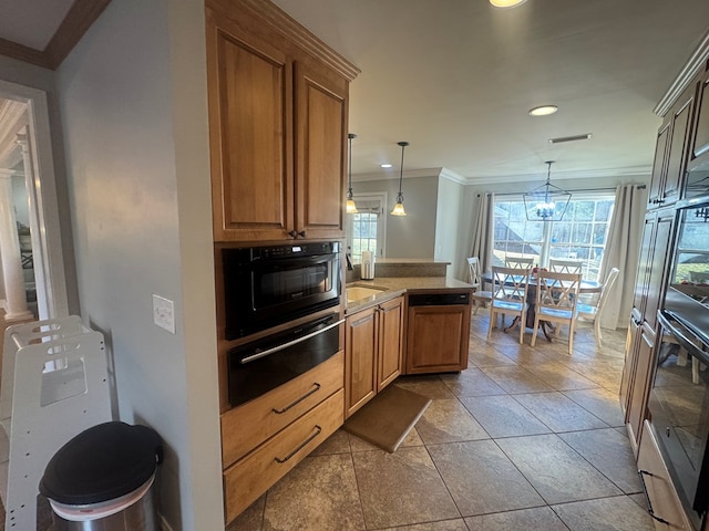 kitchen with decorative light fixtures, sink, oven, ornamental molding, and kitchen peninsula