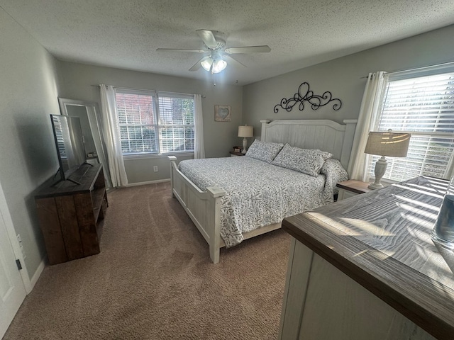 bedroom featuring multiple windows, carpet floors, and a textured ceiling