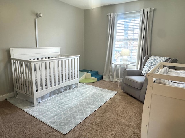 carpeted bedroom with a nursery area