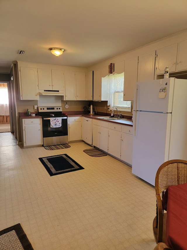 kitchen with white cabinetry, sink, and white appliances