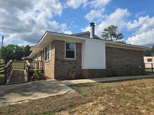 view of side of property featuring brick siding