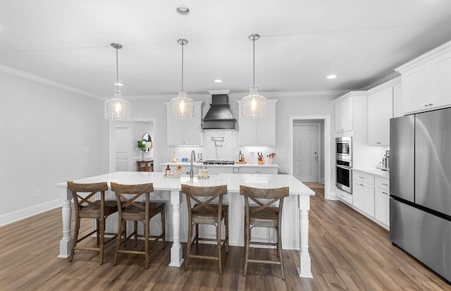 652 Charleston Mills Dr, Dothan, AL 36350 - kitchen featuring light countertops, a center island with sink, custom range hood, decorative backsplash, and stainless steel appliances