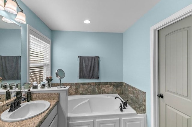 bathroom with a bath and vanity