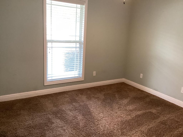 116 Jules Ln, Ashford, AL 36312 - empty room featuring dark colored carpet and baseboards