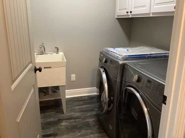 116 Jules Ln, Ashford, AL 36312 - washroom featuring dark wood-style floors, cabinet space, washer and clothes dryer, and baseboards