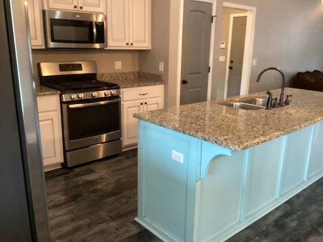 116 Jules Ln, Ashford, AL 36312 - kitchen featuring appliances with stainless steel finishes, a sink, white cabinets, light stone counters, and dark wood-style floors