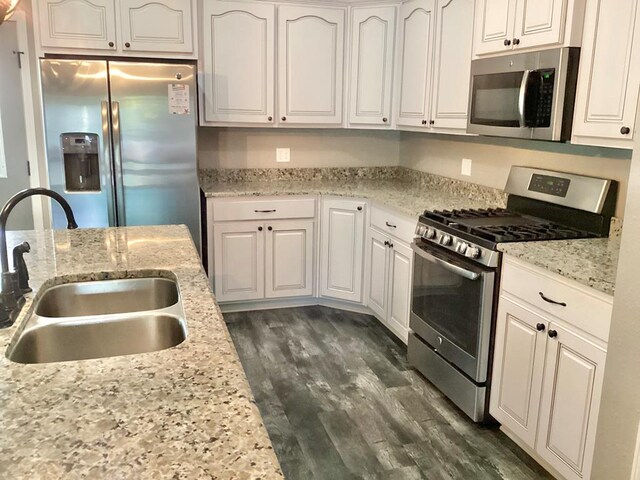 116 Jules Ln, Ashford, AL 36312 - kitchen featuring stainless steel appliances, a sink, white cabinets, dark wood-type flooring, and light stone countertops