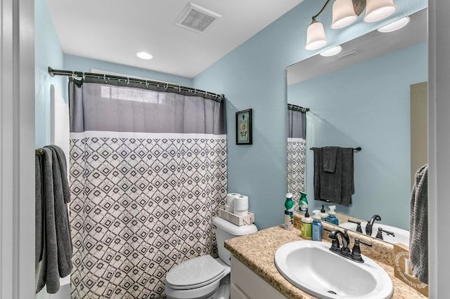 bathroom with a shower with curtain, toilet, vanity, and visible vents