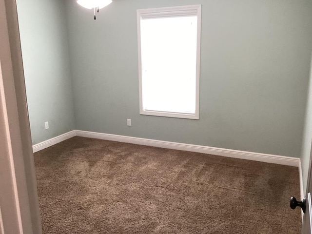 116 Jules Ln, Ashford, AL 36312 - empty room featuring dark colored carpet and baseboards