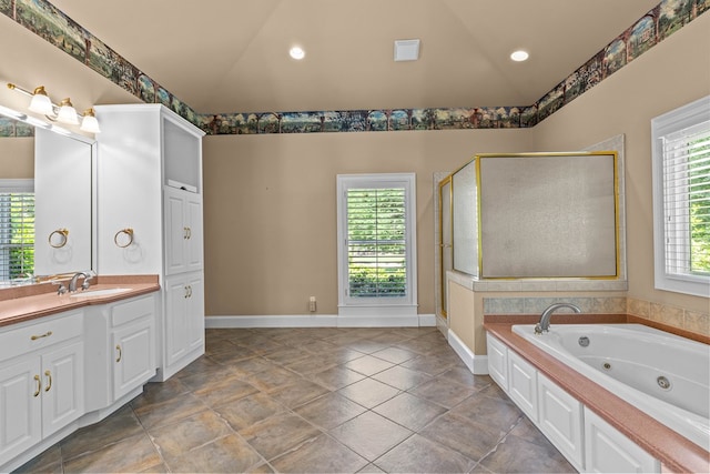 601 Edinburgh Way, Dothan, AL 36305 - full bath with lofted ceiling, vanity, a jetted tub, a shower stall, and baseboards