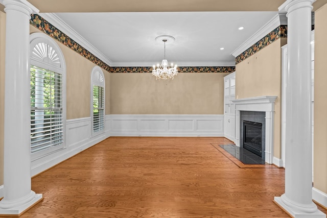 601 Edinburgh Way, Dothan, AL 36305 - unfurnished dining area featuring decorative columns, ornamental molding, a chandelier, a fireplace, and a wainscoted wall