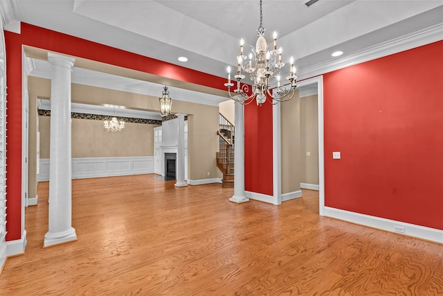 601 Edinburgh Way, Dothan, AL 36305 - unfurnished living room featuring a chandelier, a raised ceiling, stairs, wood finished floors, and a fireplace with flush hearth