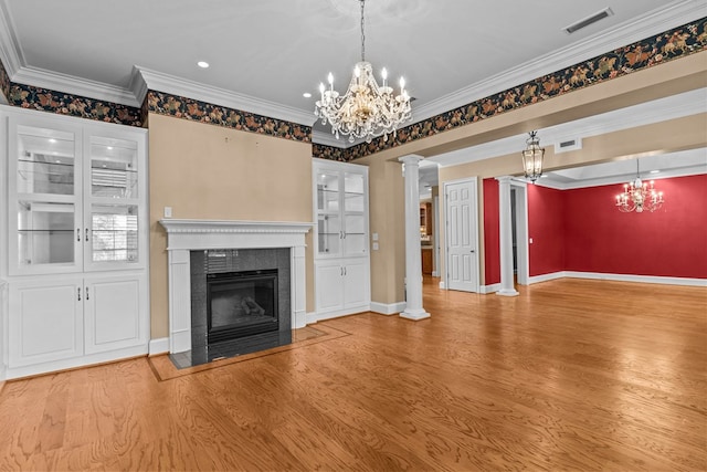 601 Edinburgh Way, Dothan, AL 36305 - unfurnished living room featuring a chandelier, a tile fireplace, wood finished floors, decorative columns, and ornamental molding