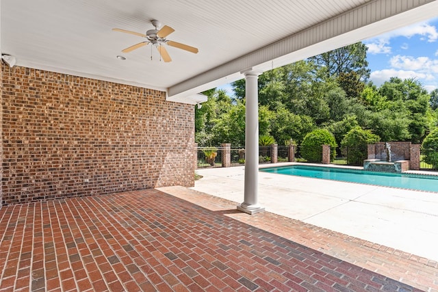 601 Edinburgh Way, Dothan, AL 36305 - view of swimming pool featuring a ceiling fan, view of wooded area, a patio area, and a pool with connected hot tub