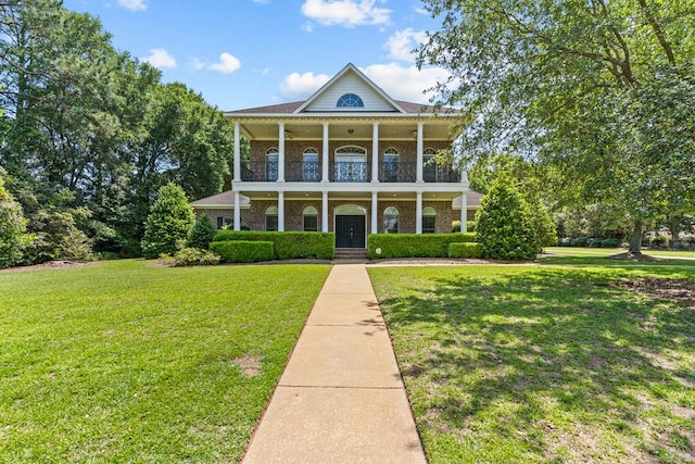 601 Edinburgh Way, Dothan, AL 36305 - greek revival inspired property with a balcony, a front lawn, covered porch, and brick siding