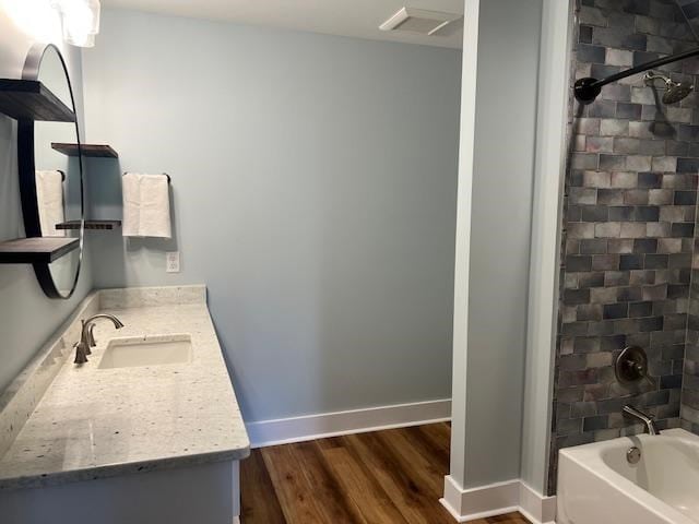 1015 Hardy Rd, Dothan, AL 36301 - bathroom featuring vanity, wood finished floors, and bathtub / shower combination