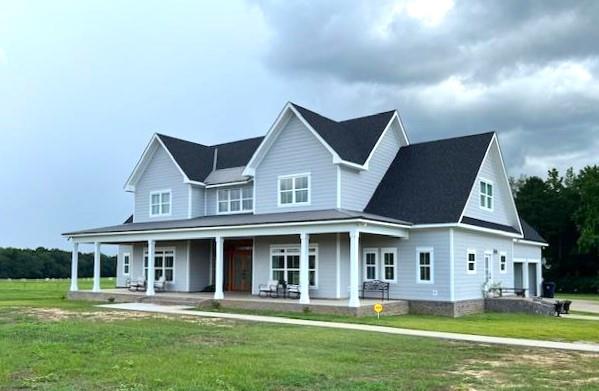 1015 Hardy Rd, Dothan, AL 36301 - country-style home with covered porch and a front yard