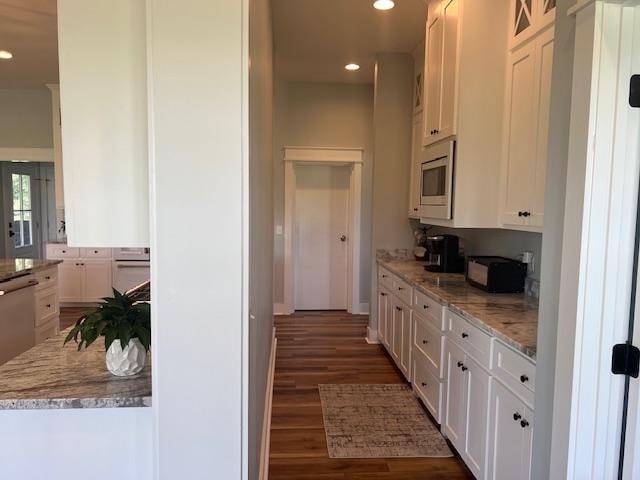 1015 Hardy Rd, Dothan, AL 36301 - kitchen with white cabinets, dark wood-style flooring, recessed lighting, stainless steel appliances, and light stone countertops