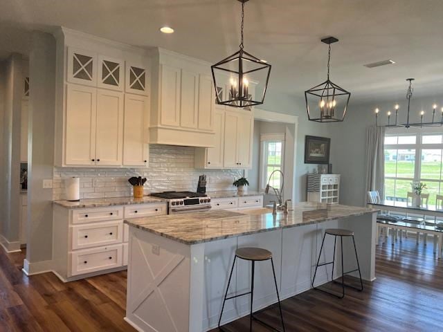 1015 Hardy Rd, Dothan, AL 36301 - kitchen featuring stainless steel gas stove, dark wood-style floors, backsplash, white cabinets, and recessed lighting