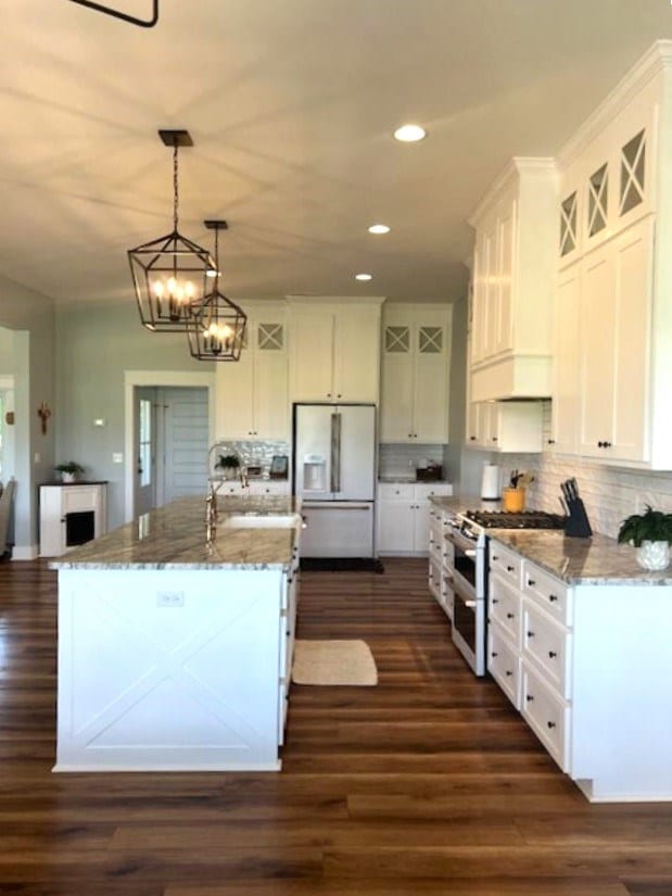 1015 Hardy Rd, Dothan, AL 36301 - kitchen featuring white refrigerator with ice dispenser, double oven range, white cabinetry, dark wood finished floors, and backsplash