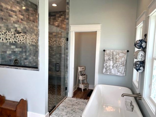 1015 Hardy Rd, Dothan, AL 36301 - full bathroom with a freestanding tub, a shower stall, wood finished floors, and recessed lighting