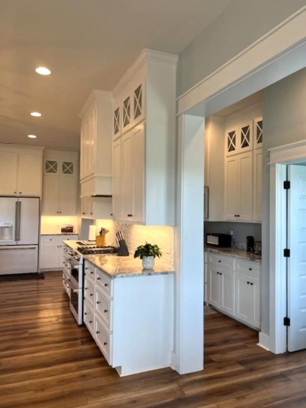 1015 Hardy Rd, Dothan, AL 36301 - kitchen with white appliances, dark wood-style flooring, white cabinetry, and recessed lighting