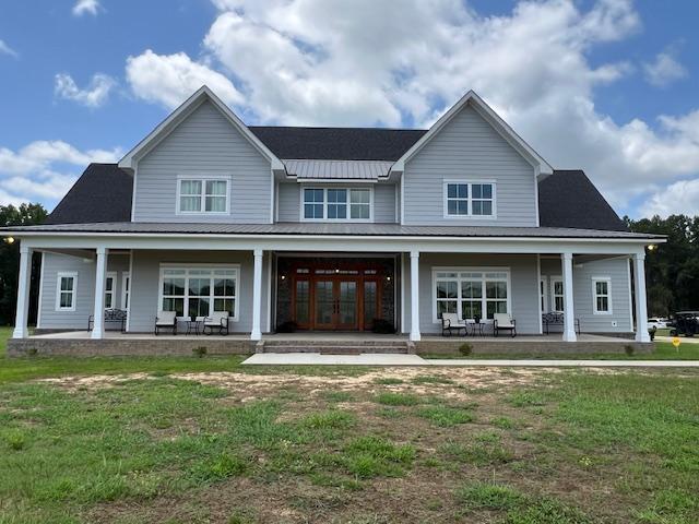1015 Hardy Rd, Dothan, AL 36301 - view of front of property with a porch, a front yard, and a metal roof