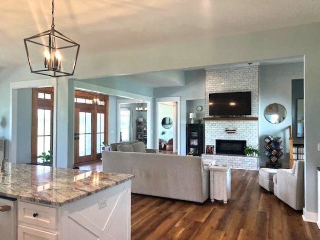 1015 Hardy Rd, Dothan, AL 36301 - living area featuring a chandelier, dark wood finished floors, and a fireplace