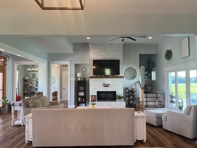 1015 Hardy Rd, Dothan, AL 36301 - living room featuring a ceiling fan, a brick fireplace, dark wood-style flooring, a chandelier, and recessed lighting