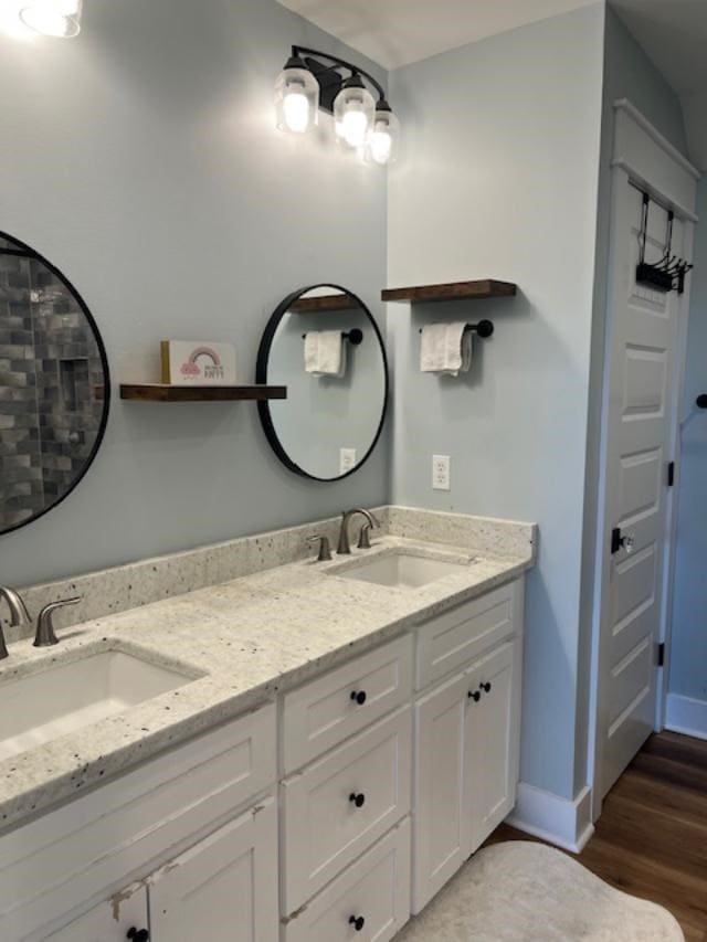1015 Hardy Rd, Dothan, AL 36301 - bathroom featuring double vanity and wood finished floors
