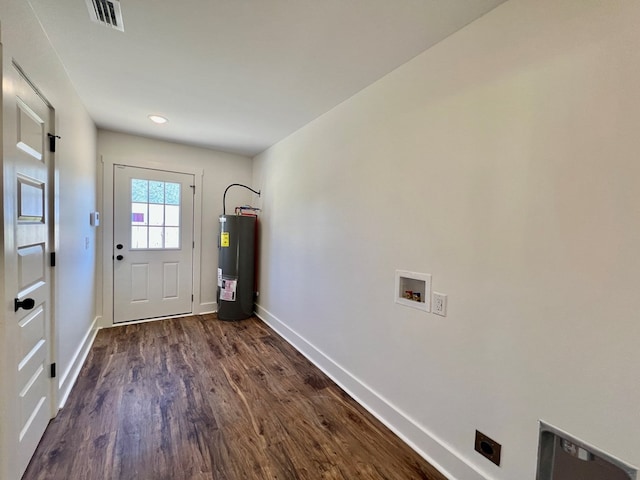 doorway to outside with dark hardwood / wood-style floors and water heater