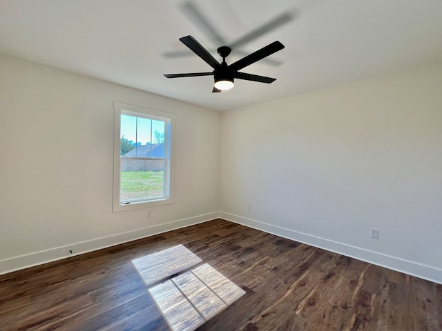 empty room with ceiling fan and dark hardwood / wood-style flooring