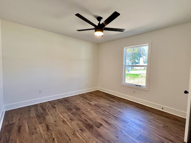 empty room featuring ceiling fan and dark hardwood / wood-style flooring