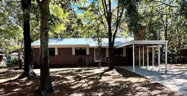 511 W Franklin St, Dothan, AL 36301 - ranch-style house featuring a chimney, an attached carport, crawl space, brick siding, and metal roof