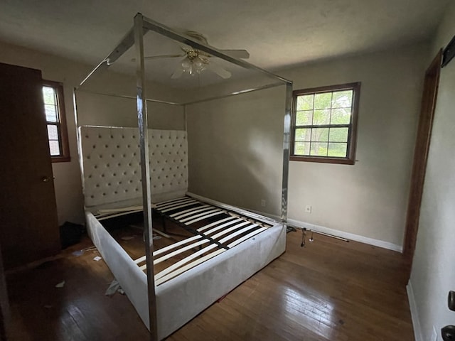 511 W Franklin St, Dothan, AL 36301 - unfurnished bedroom with wood finished floors, baseboards, and a ceiling fan