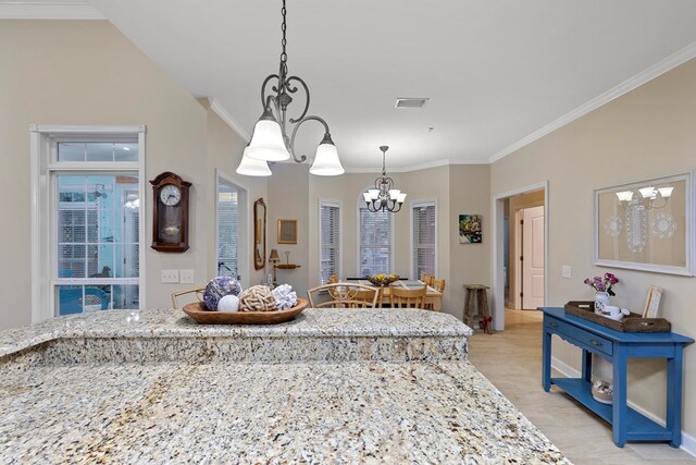 interior space featuring light stone countertops, crown molding, and a chandelier