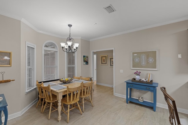 dining area with crown molding and an inviting chandelier