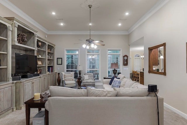 carpeted living room with ceiling fan and ornamental molding